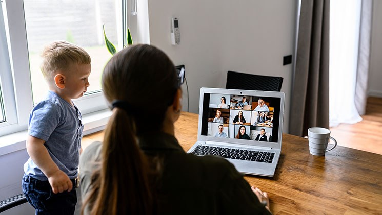 Business mom using laptop for online video meeting with employees on a laptop, mom with a kid looks at laptop screen, webcam shots of people on it, video conference